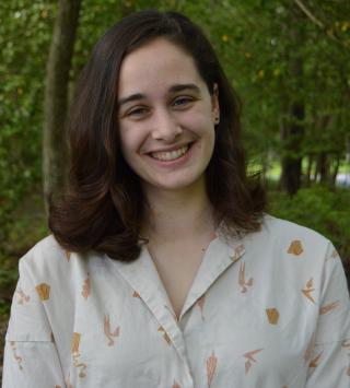 Katherine Gill, brown hair, blue eyes in a light brown button down shirt. 